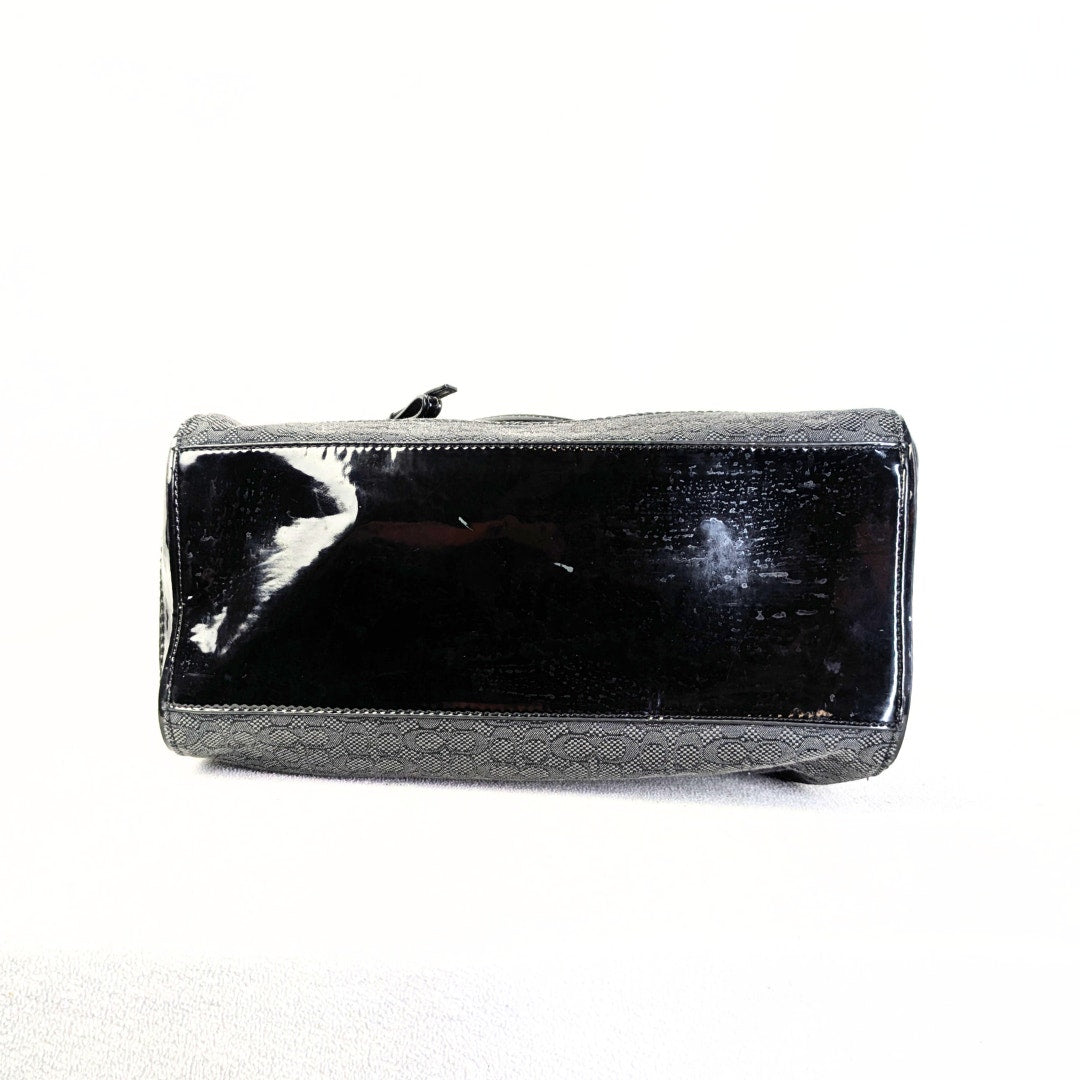 The view of the bottom of the COACH Poppy Mini Oxford Convertible Satchel Handbag photographed on the white background.