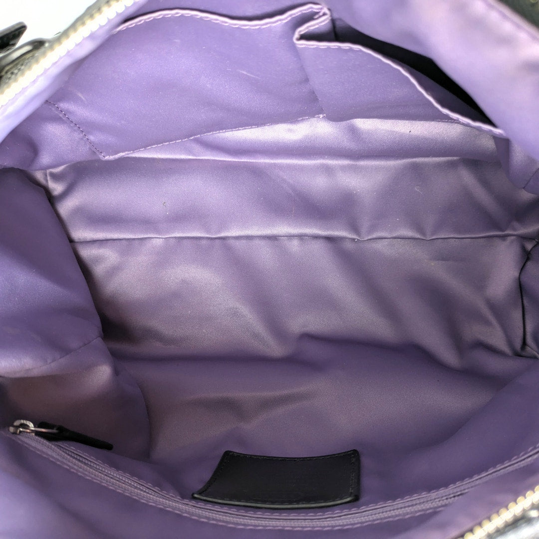 The interior polyester lining of the COACH Poppy Mini Oxford Convertible Satchel Handbag.