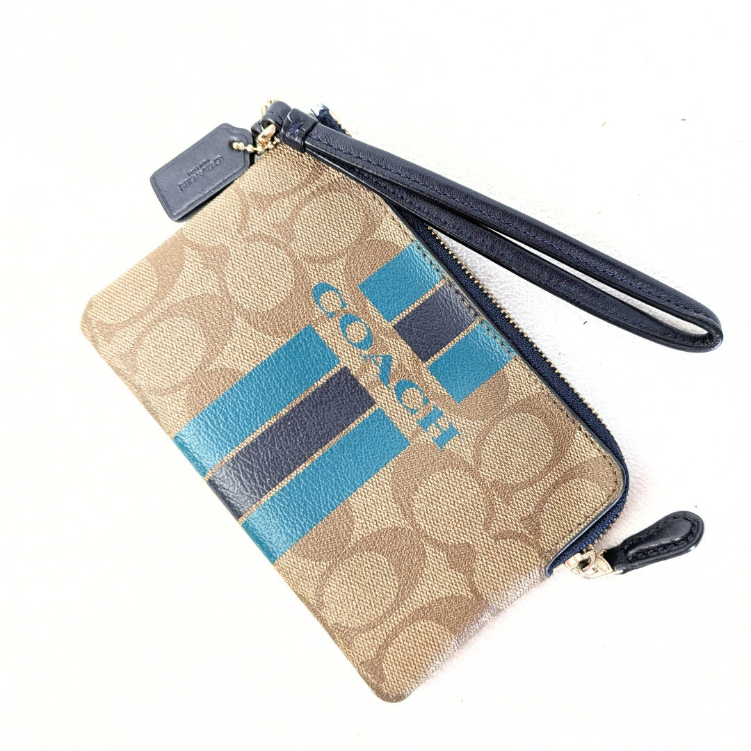 The COACH Signature Canvas Stripe Wallet Pouch photographed on the white background.