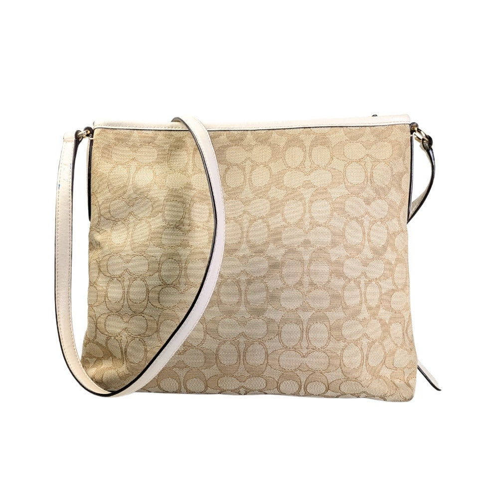 The back side of the COACH Signature Jacquard Crossbody Bag.