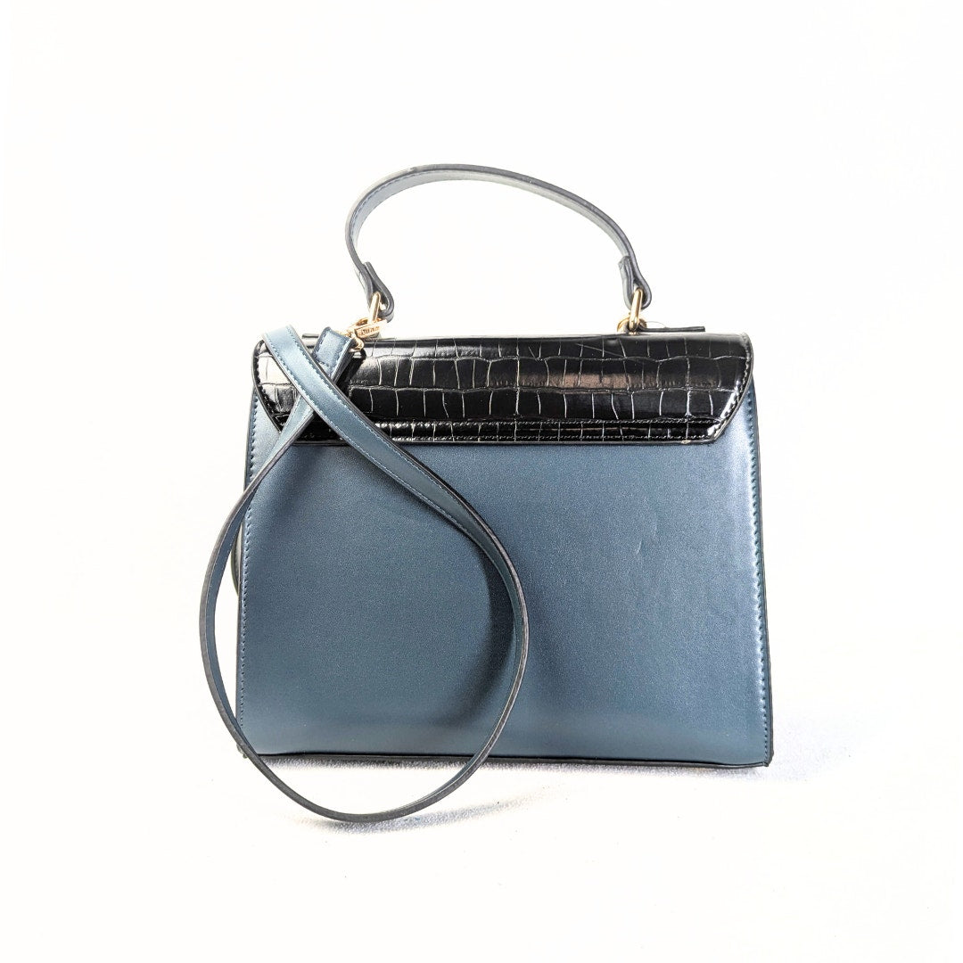 Dune London Purce Convertible Crossbody Satchel Handbag With a Wallet photographed from the back on the white background.