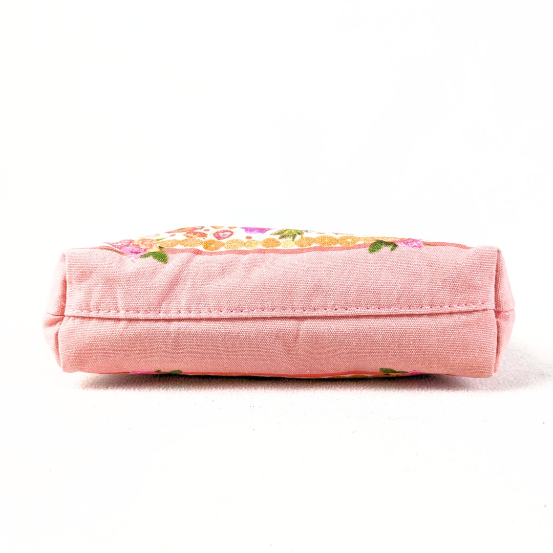 The bottom of the Estée Lauder Small Citrus Fruits Print Makeup Bag, captured on the white background.