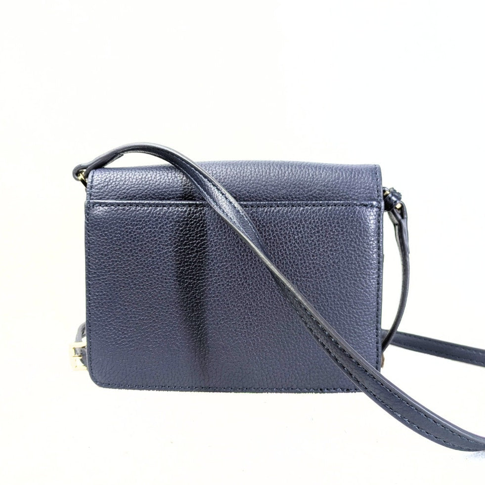 The back view of the Isaac Mizrahi Floral Print Faux Leather Crossbody Bag on the white background.