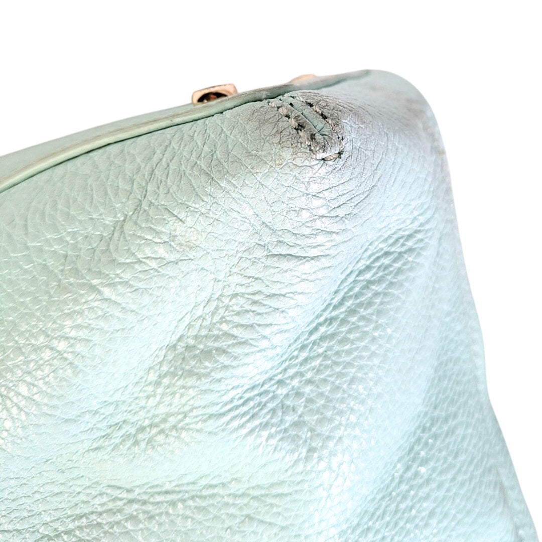 The close-up on the worn down bototm corners of the Kate Spade Emerson Place Margot Crossbody Satchel Bag.