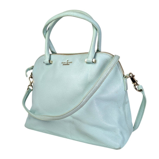 A light turquoise Kate Spade Emerson Place Margot Crossbody Satchel Bag with gold-tone hardware, shown with both a hand and an adjustable crossbody strap.