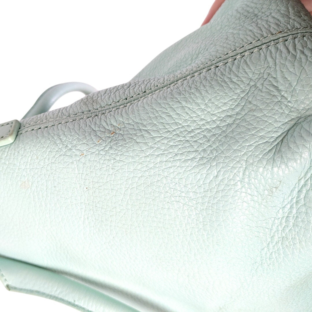 The close-up of the stain mark on the pebbled leather.