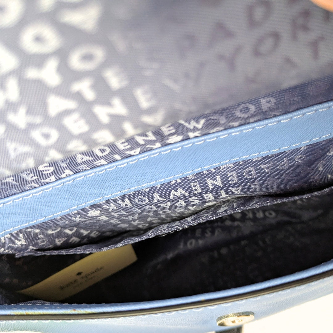 The view of the interior of the Kate Spade Laurel Way Mini Alisanne Leather Crossbody Satchel Handbag.