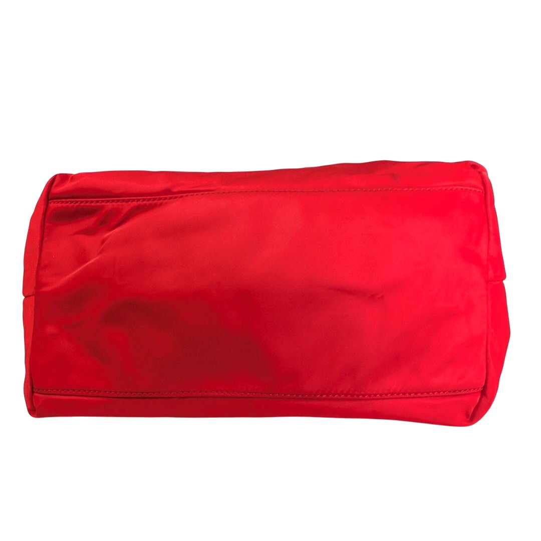 The bottom of the Kate Spade May Street Lida Large Tote Shoulder Bag in Red on the white background.