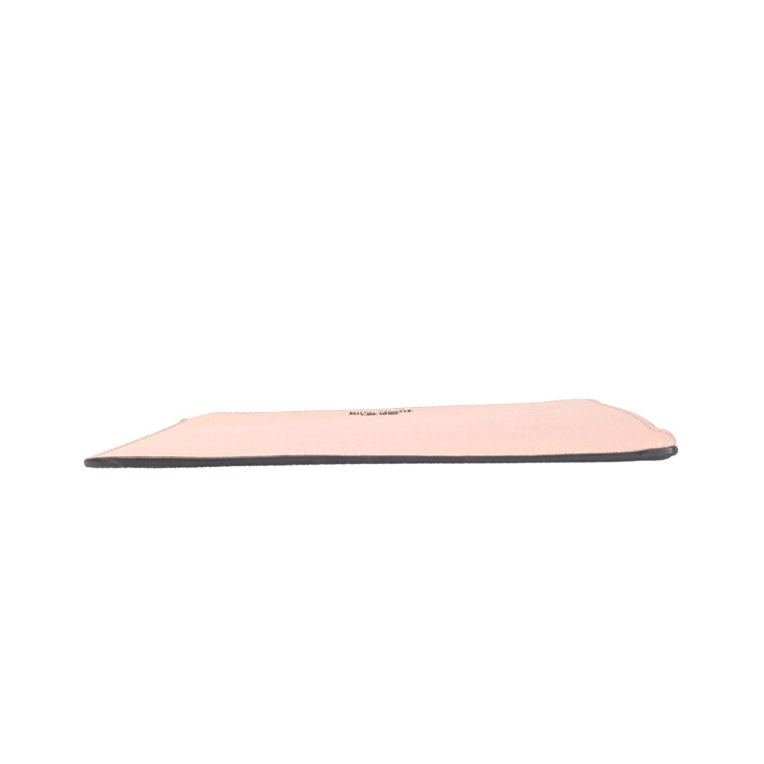 The view of a bottom of the pink wristlet on a white background