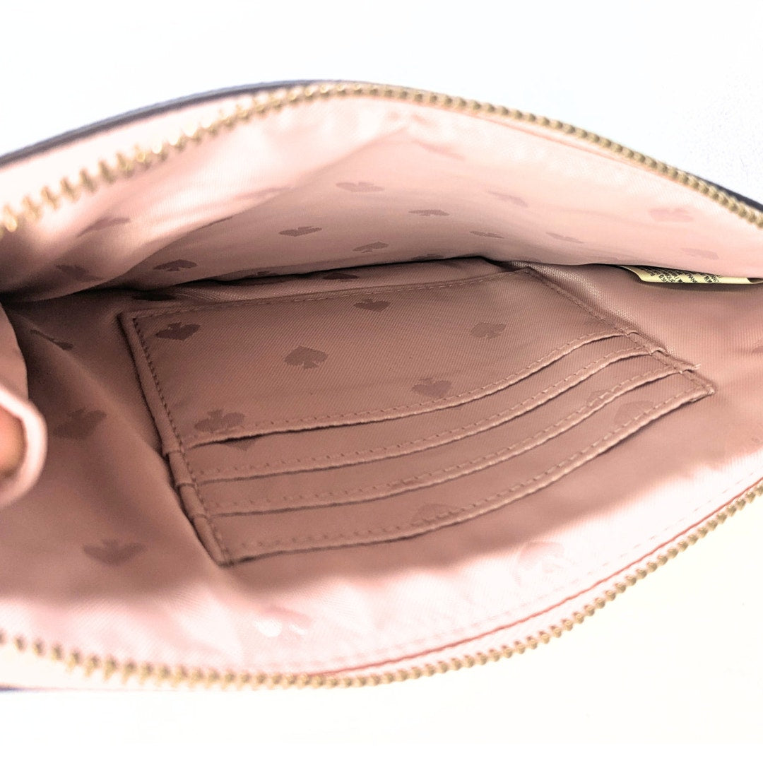 The view of the interior lining inside the Kate Spade New York Leather Wristlet.