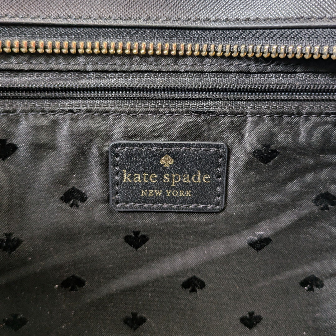 The view of the logo patch inside the Kate Spade Shore Street Sailing Stripe Margareta Tote Shoulder Bag.