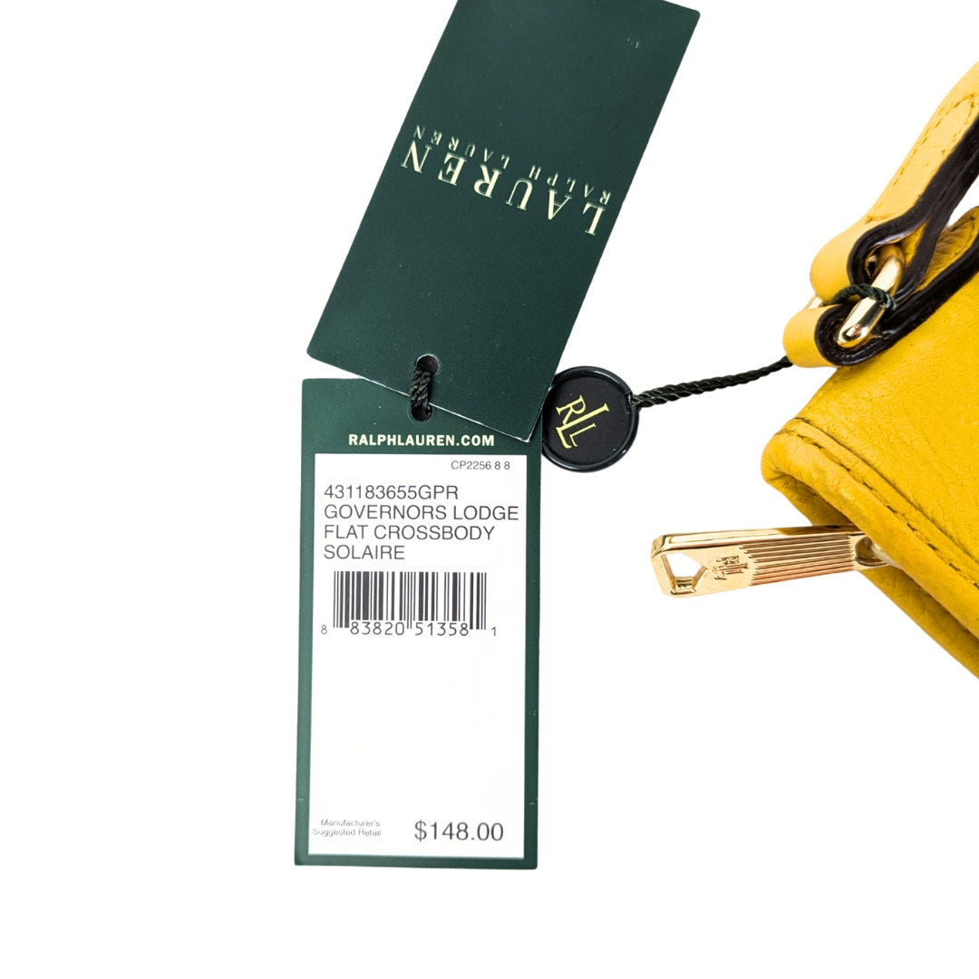 Yellow crossbody bag with price tag and branding details.