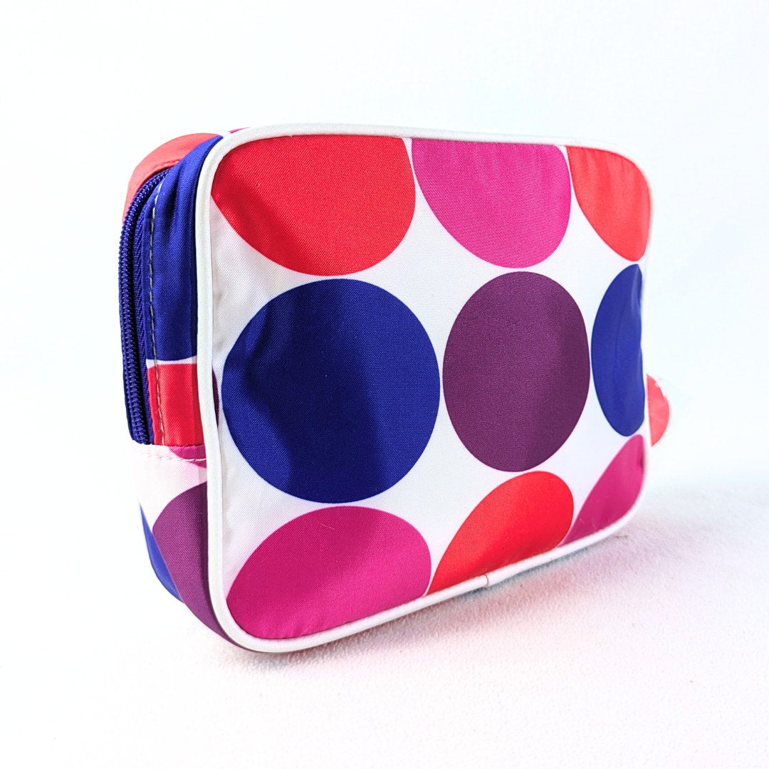 The back side of the Lisa Perry for Estée Lauder Geometric Print Make-up Bag on white background.