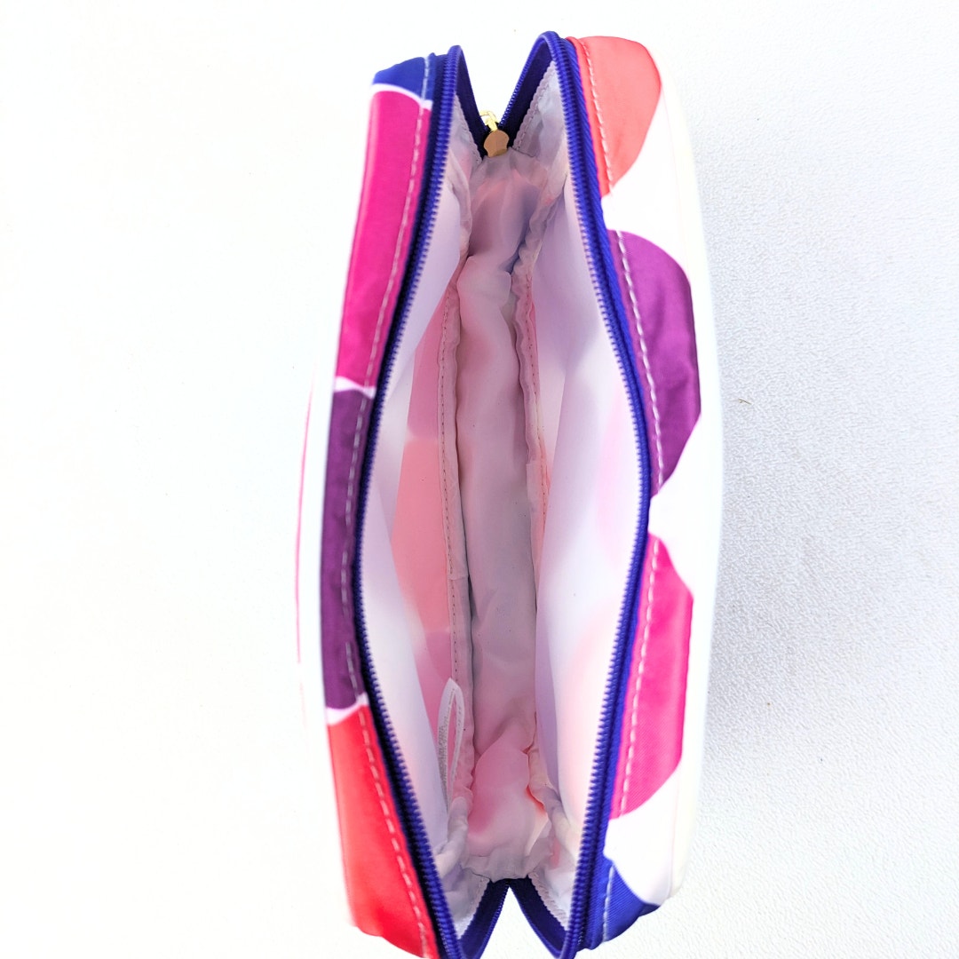 The interior of the Lisa Perry for Estée Lauder Geometric Print Make-up Bag, photographed on the white background.