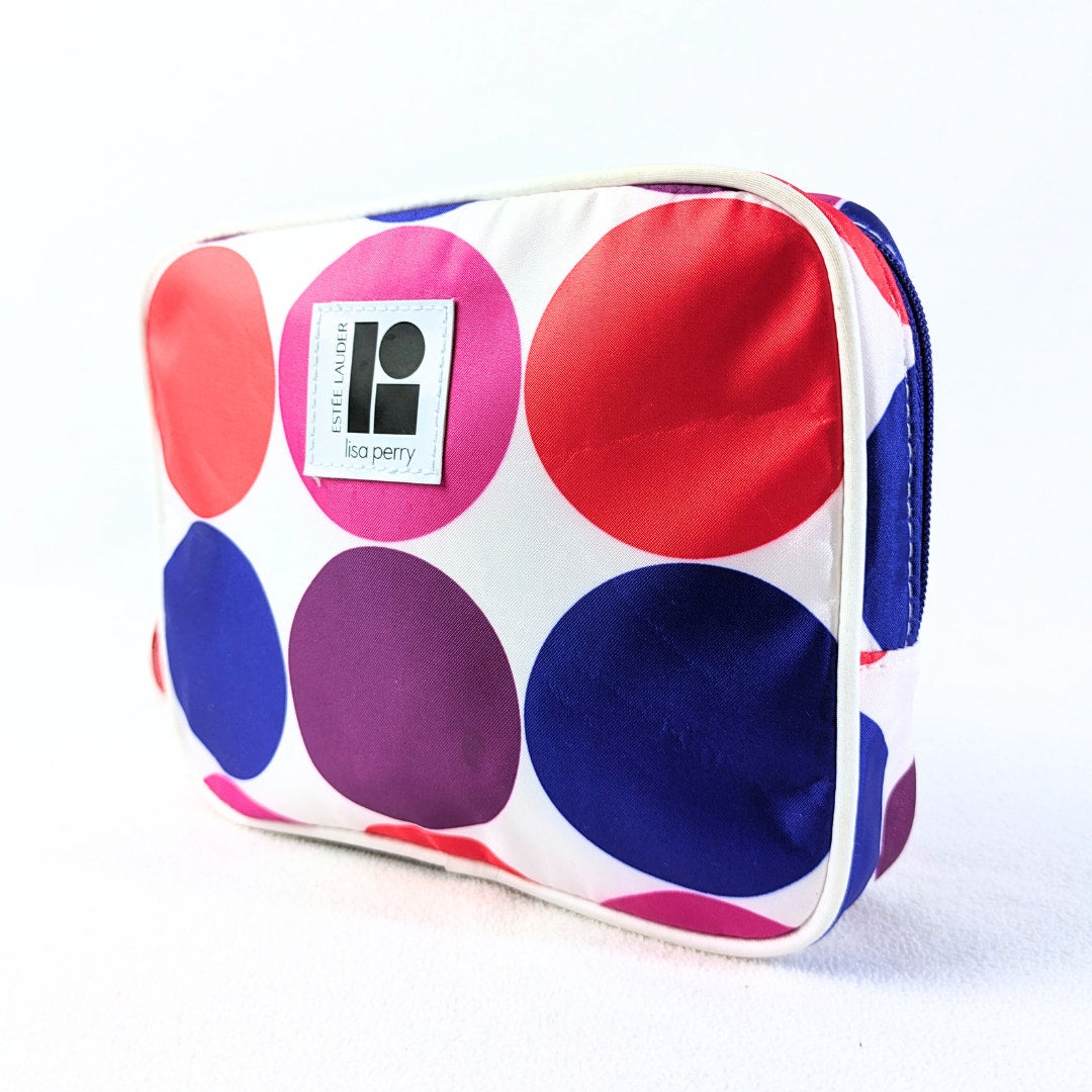A geometric print make-up bag with large colorful circles on a white background, featuring the Lisa Perry logo.