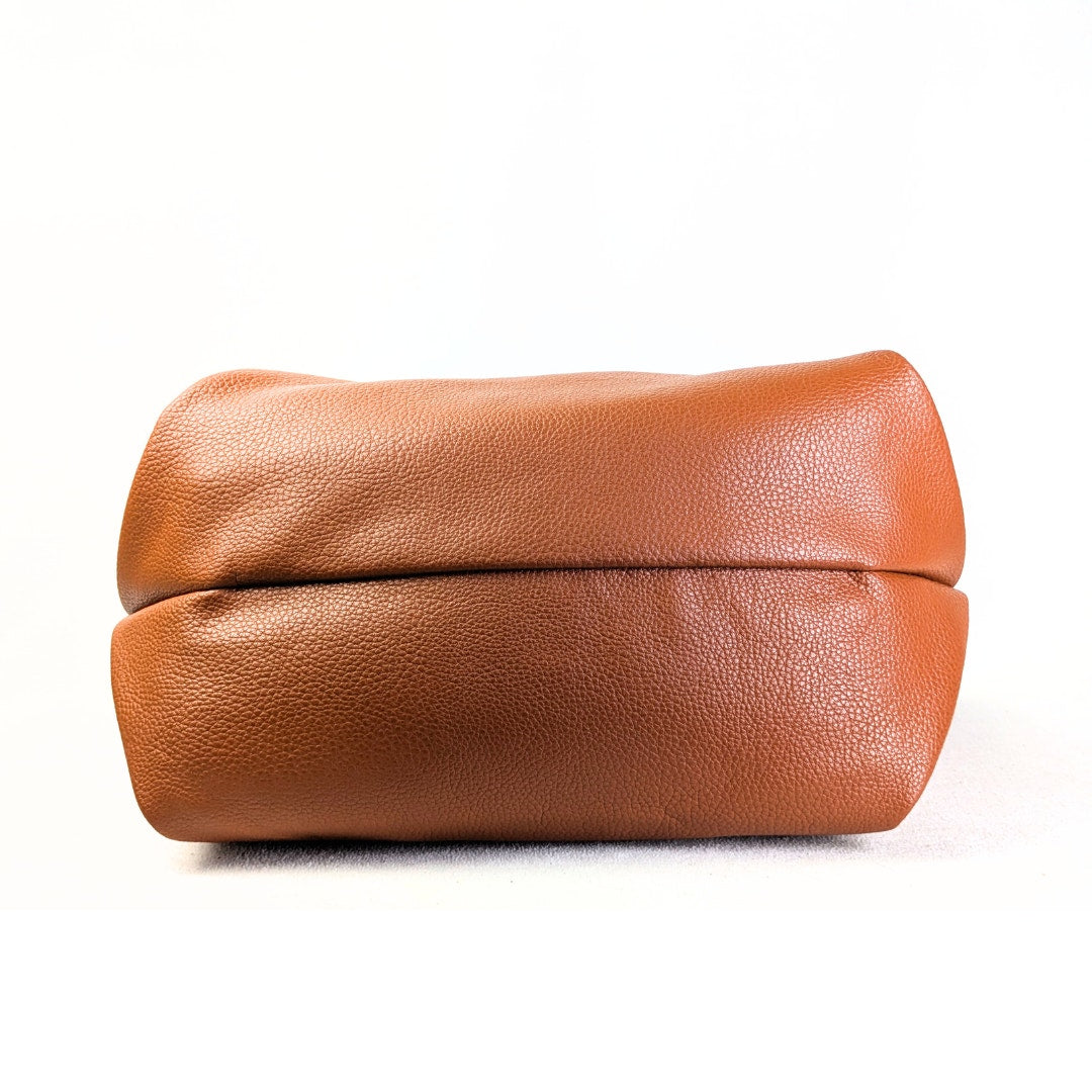 The bottom of the London Fog Faux Leather Crossbody / Shoulder Handbag in Camel.
