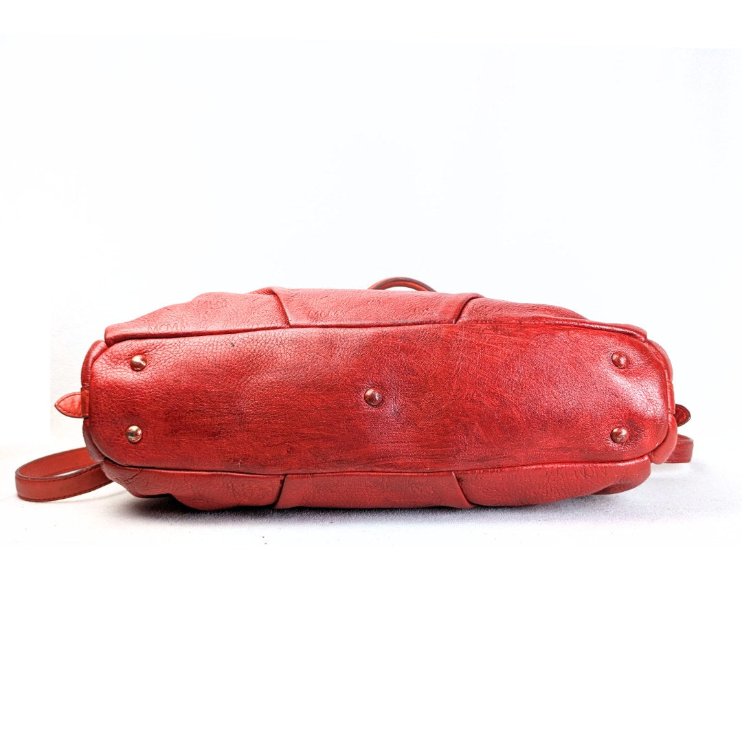 The bottom of the MCM Monogram Embossed Leather Satchel Shoulder Bag.