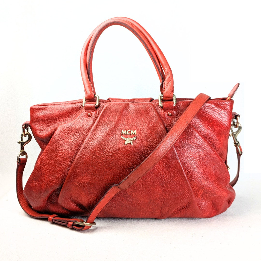 The view of the MCM Monogram Embossed Leather Satchel Shoulder Bag from the front side.