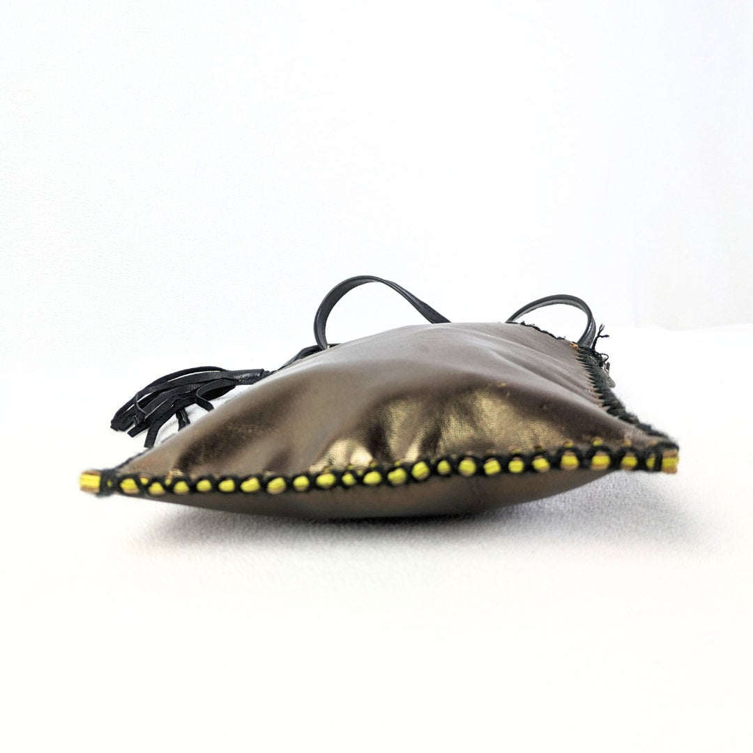 The bottom of the MUSHMINA Metallic Gold Faux Leather Crossbody Bag capture dont he white background.