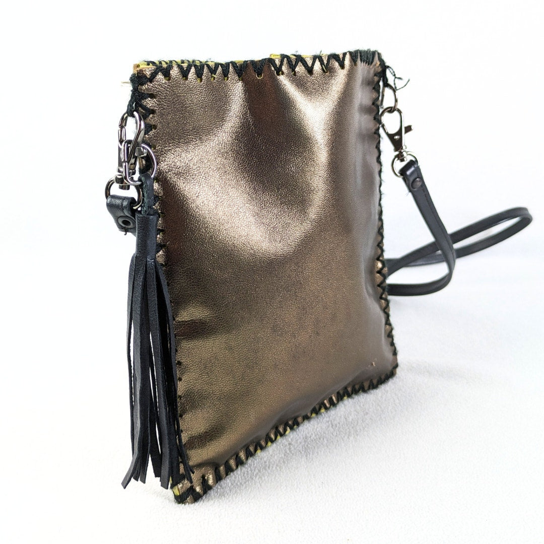 The side view of the MUSHMINA Metallic Gold Faux Leather Crossbody Bag captured on the white background.