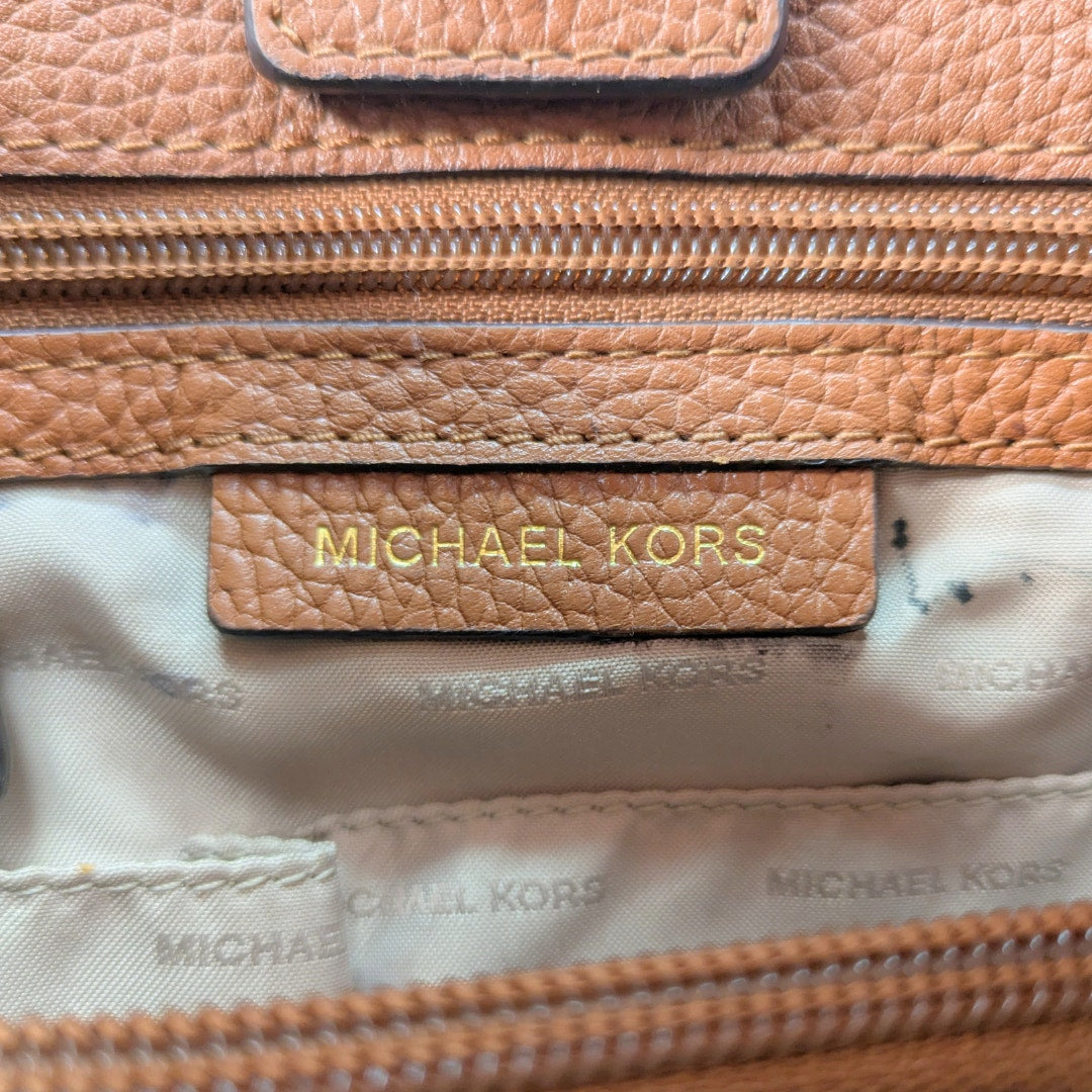 The close up of the leather embossed logo patch inside the Michael Kors Jet Set Chain Medium Tote Bag.