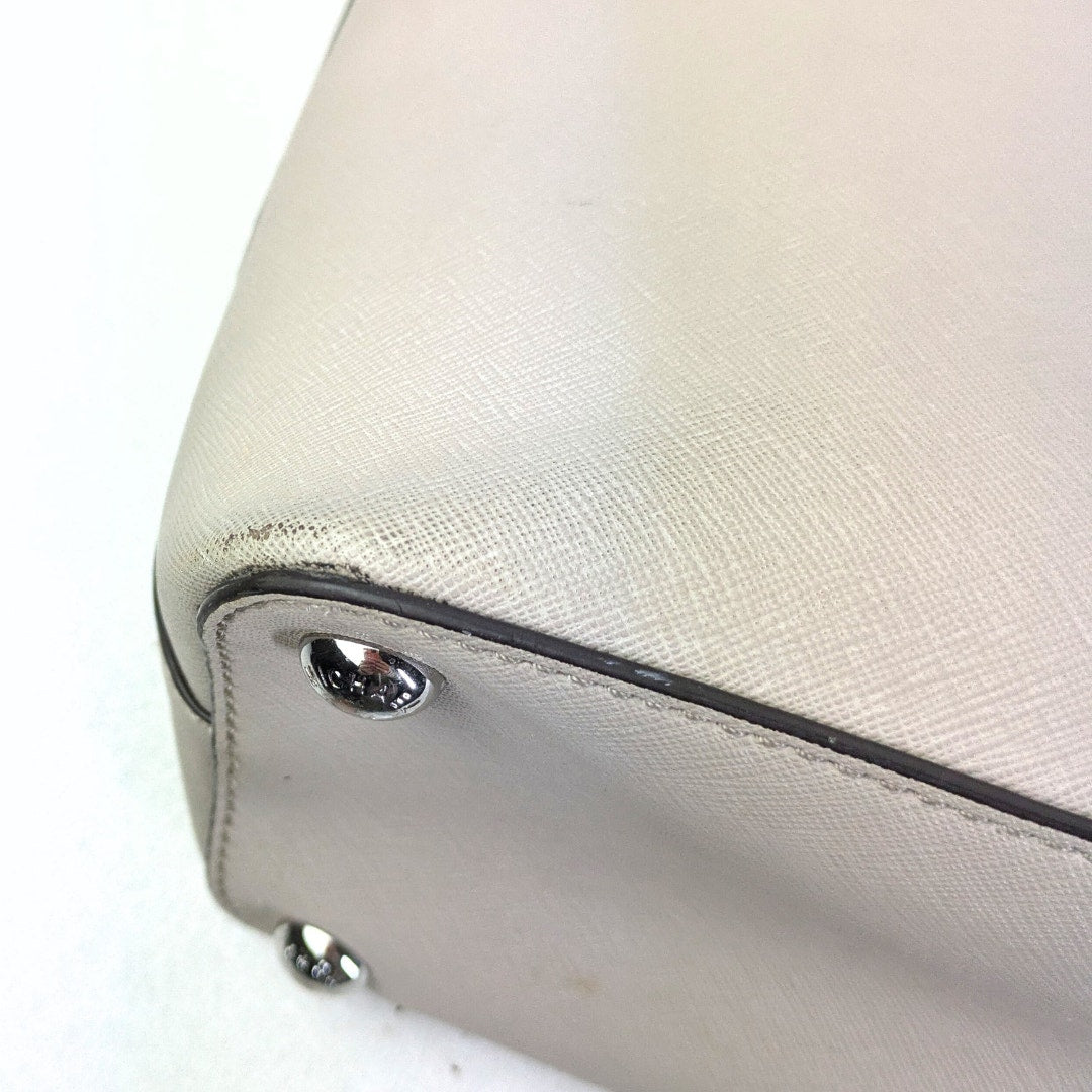 The view of the bottom right corner of the pre-loved Michael Kors Jet Set Medium Saffiano Leather Tote.
