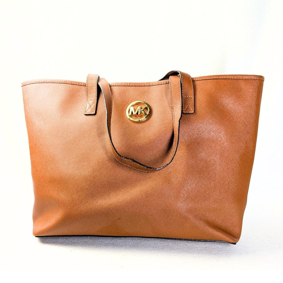 The front side of the Michael Kors Jet Set Medium Tote Bag in Camel on the white background.