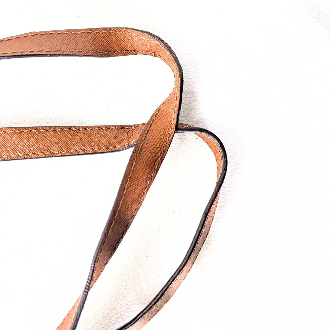 The view of Michael Kors Jet Set Medium Tote Bag' shoulder handles photographe don white background.