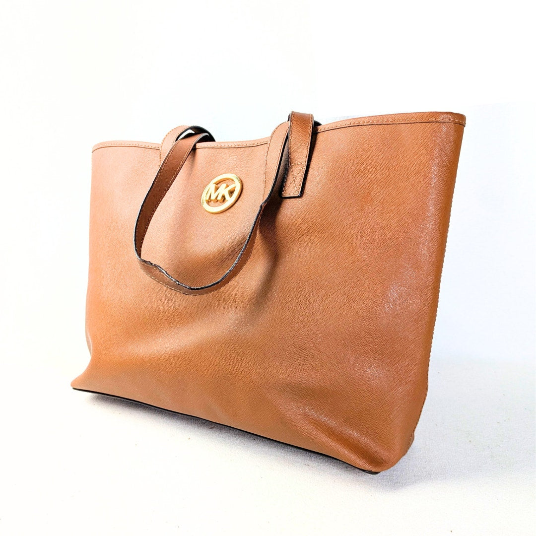 A medium-sized brown saffiano leather tote bag with Michael Kors' logo on the side.