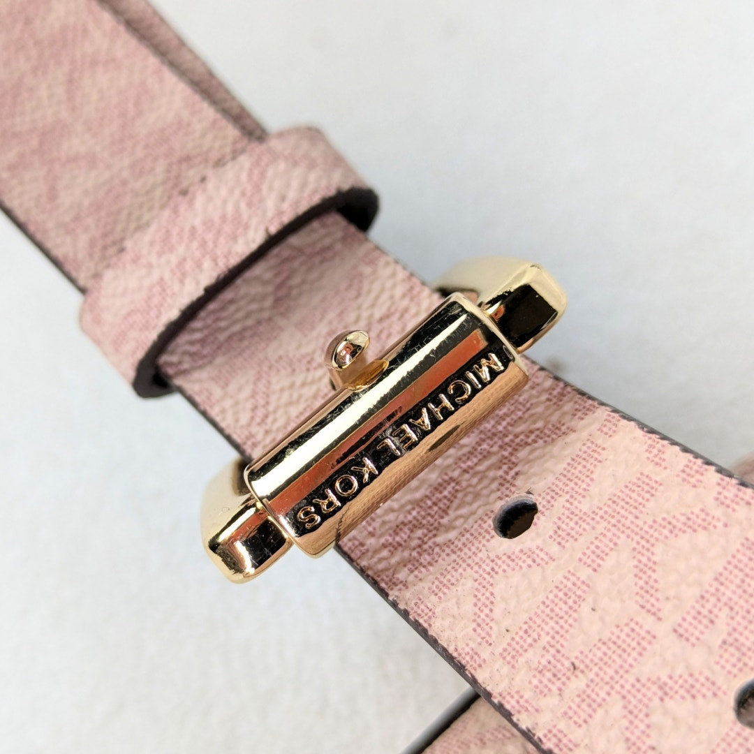 The close-up on the gold-tone hardware of the Michael Kors Signature MK Belt Wallet Waist Bag.