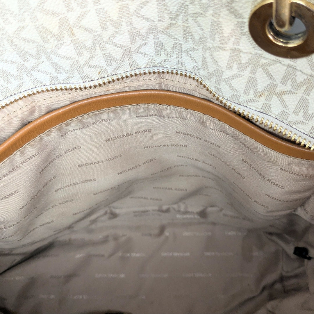 The vie wof the signature Michael Kors lining inside the Michael Kors Signature Raven Large North South Top Zip Tote.