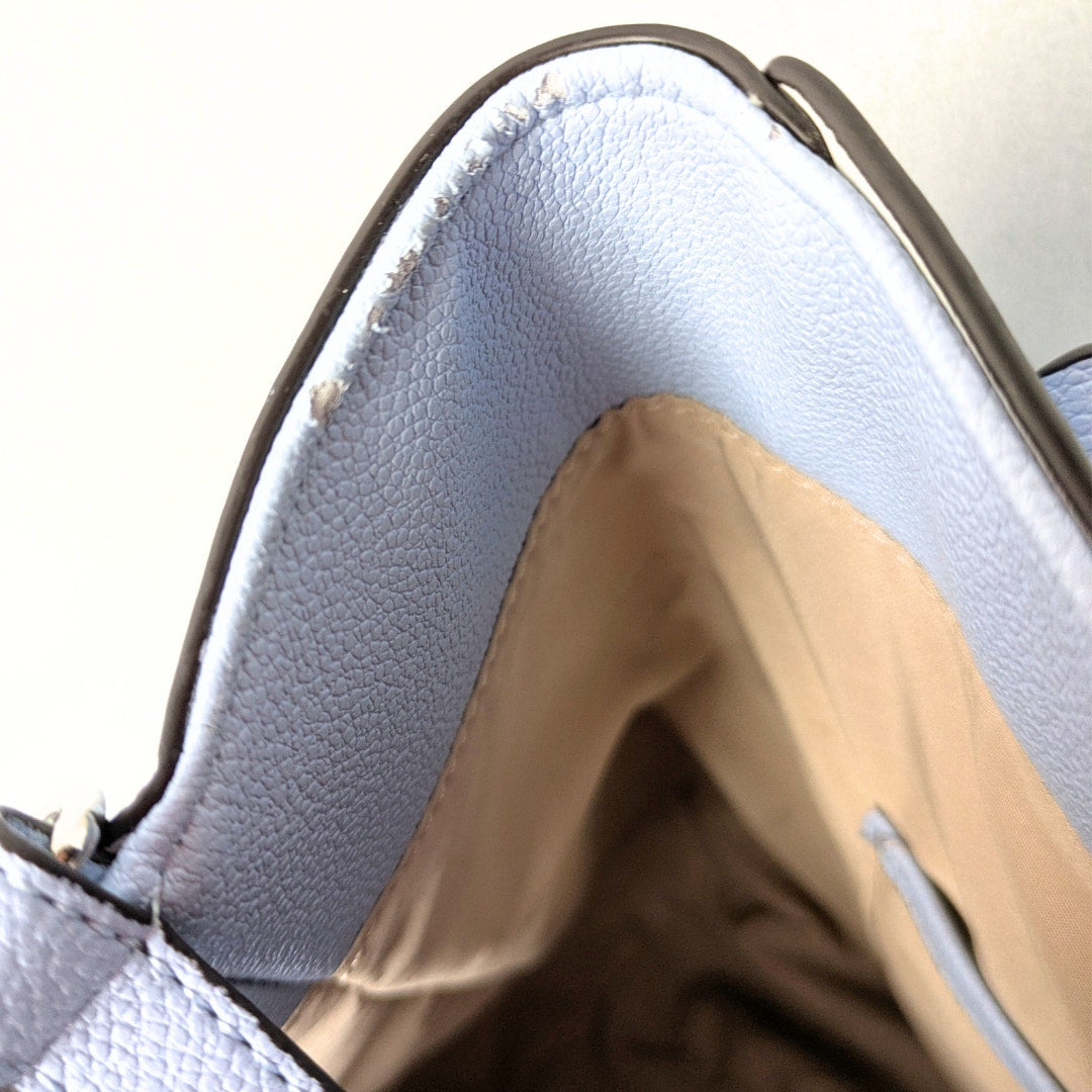 The close-up view of the damaged faux leather on the inside part of the Nine West Two-Way Tote Bag with a Crossbody Strap.