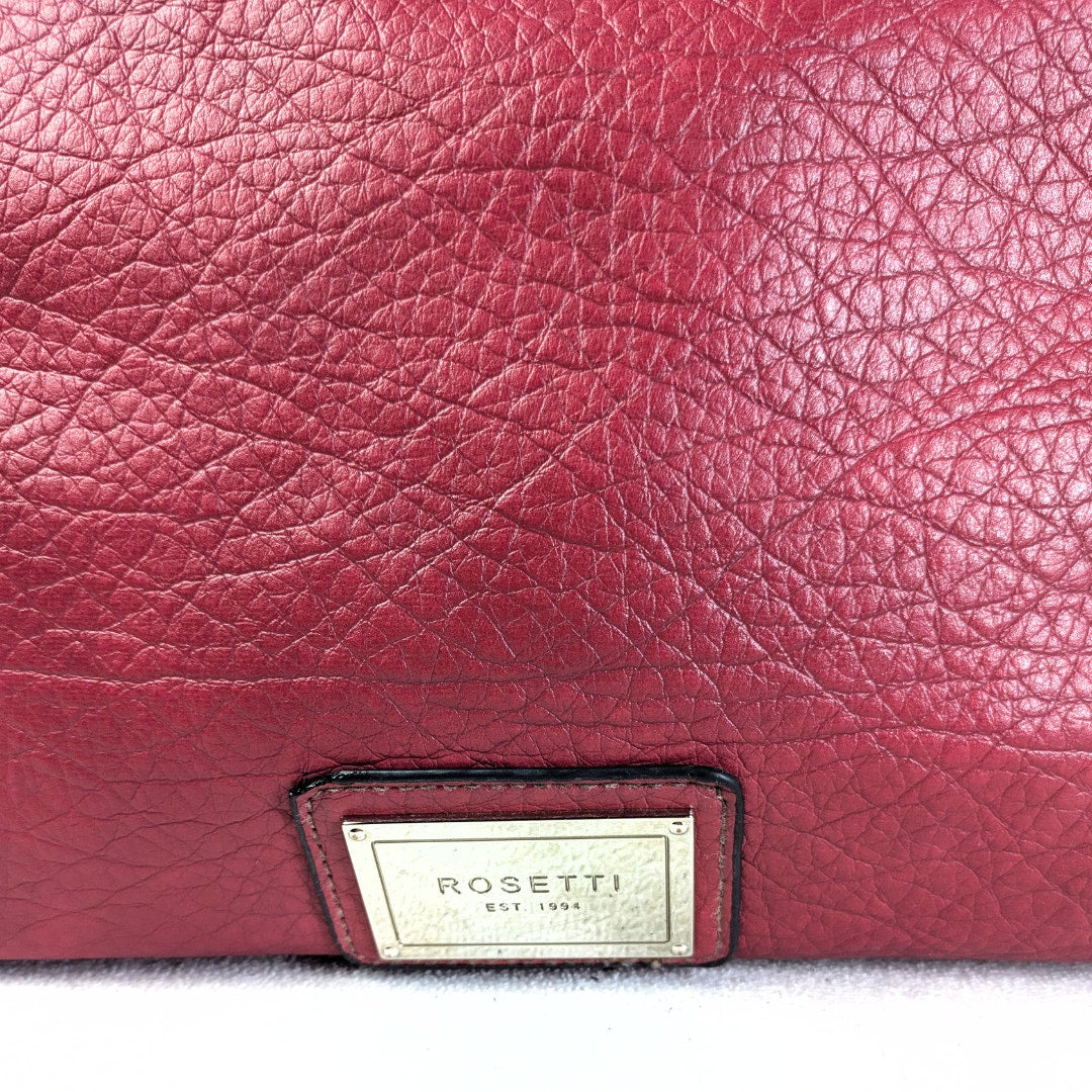 Close-up of a red leather product with 'Rossetti' label.