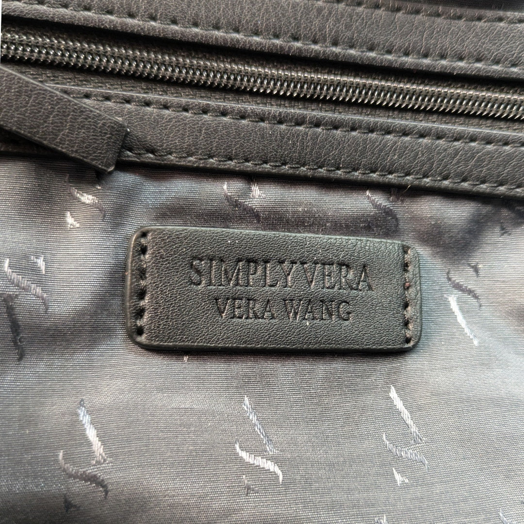 The leather embossed logo inside the Simply Vera Vera Wang Black Tote Shoulder Bag.