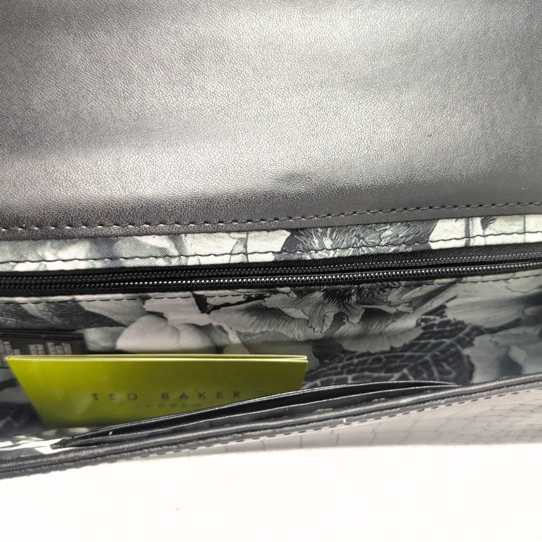 The inside lining of the Ted Baker Crocodile Embossed Leather Envelope Evening Clutch Bag.