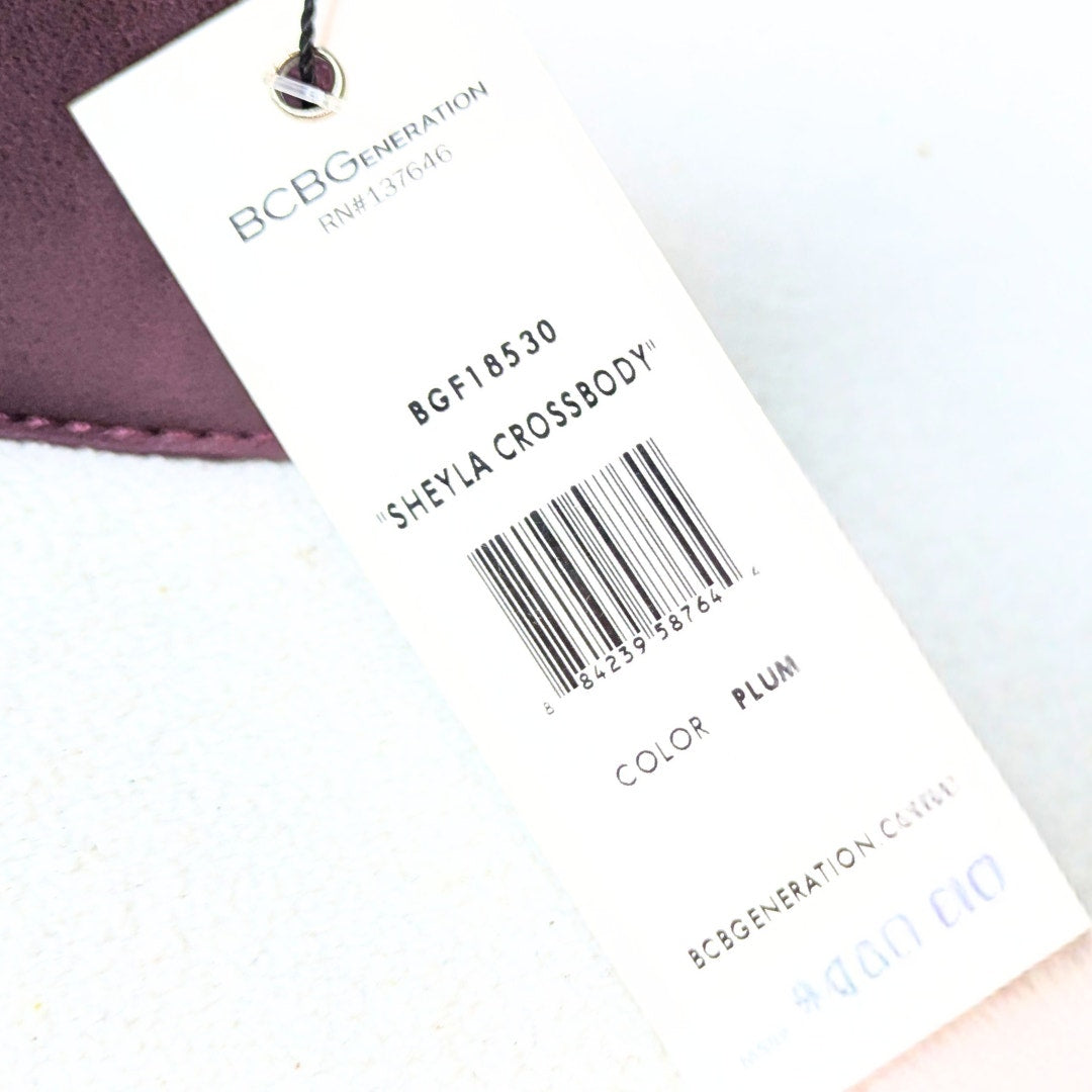 Back side of the tag for a BCBGeneration Shelya Studded Crossbody Bag in Plum 