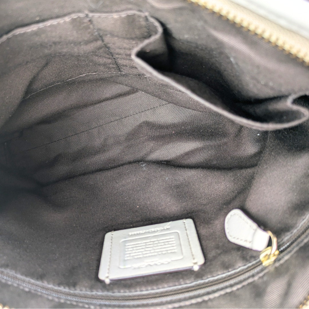 The interior of the COACH Signature Jacquard Crossbody Bag.