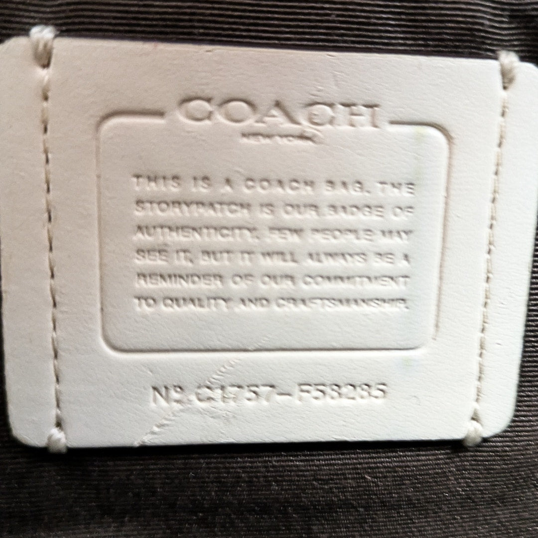 The interior creed inside the COACH Signature Jacquard Crossbody Bag.