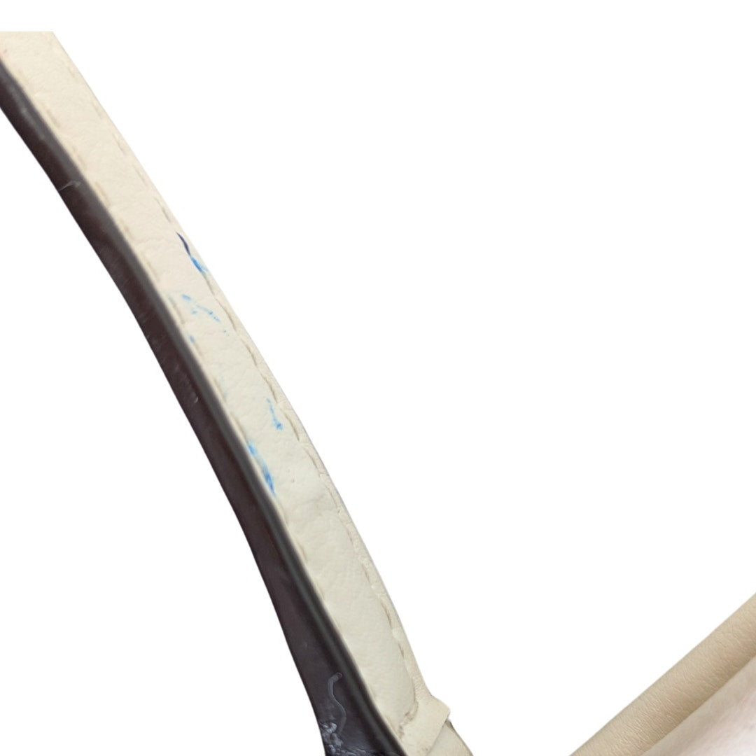 The view of pen marks located on the crossbody strap  of the COACH Signature Jacquard Crossbody Bag.