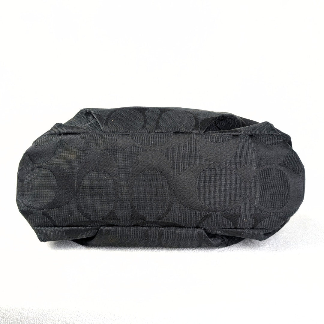 The bottom of the Coach Monogram Hobo Shoulder Bag, captured on the white background. 