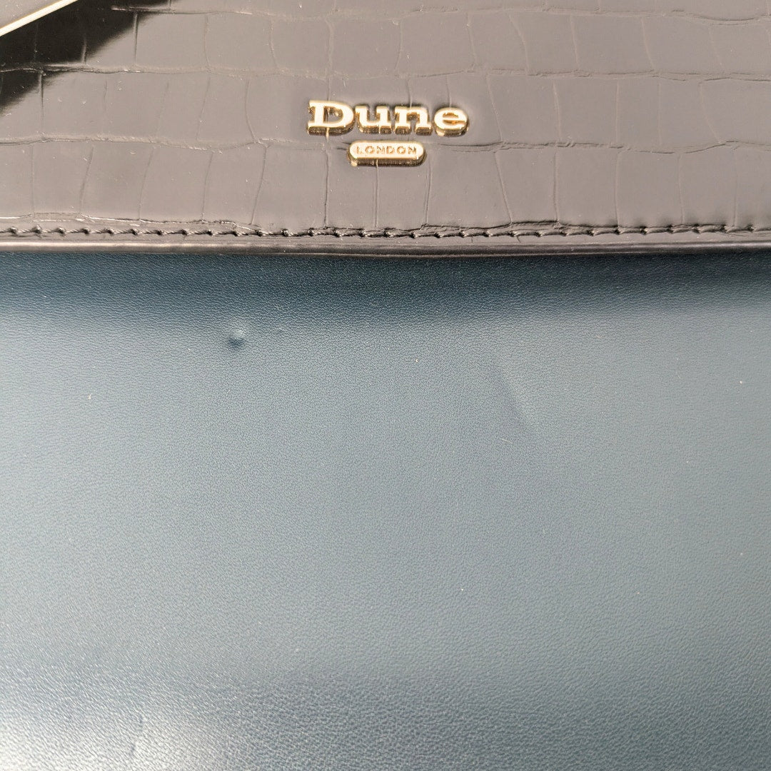 The close-up on the leather dent in the Dune London Purce Convertible Crossbody Satchel Handbag With a Wallet.