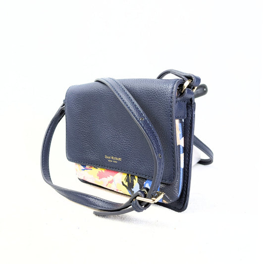 A pre-owned Isaac Mizrahi floral print faux leather crossbody bag in navy color with an adjustable strap and gold-tone hardware.