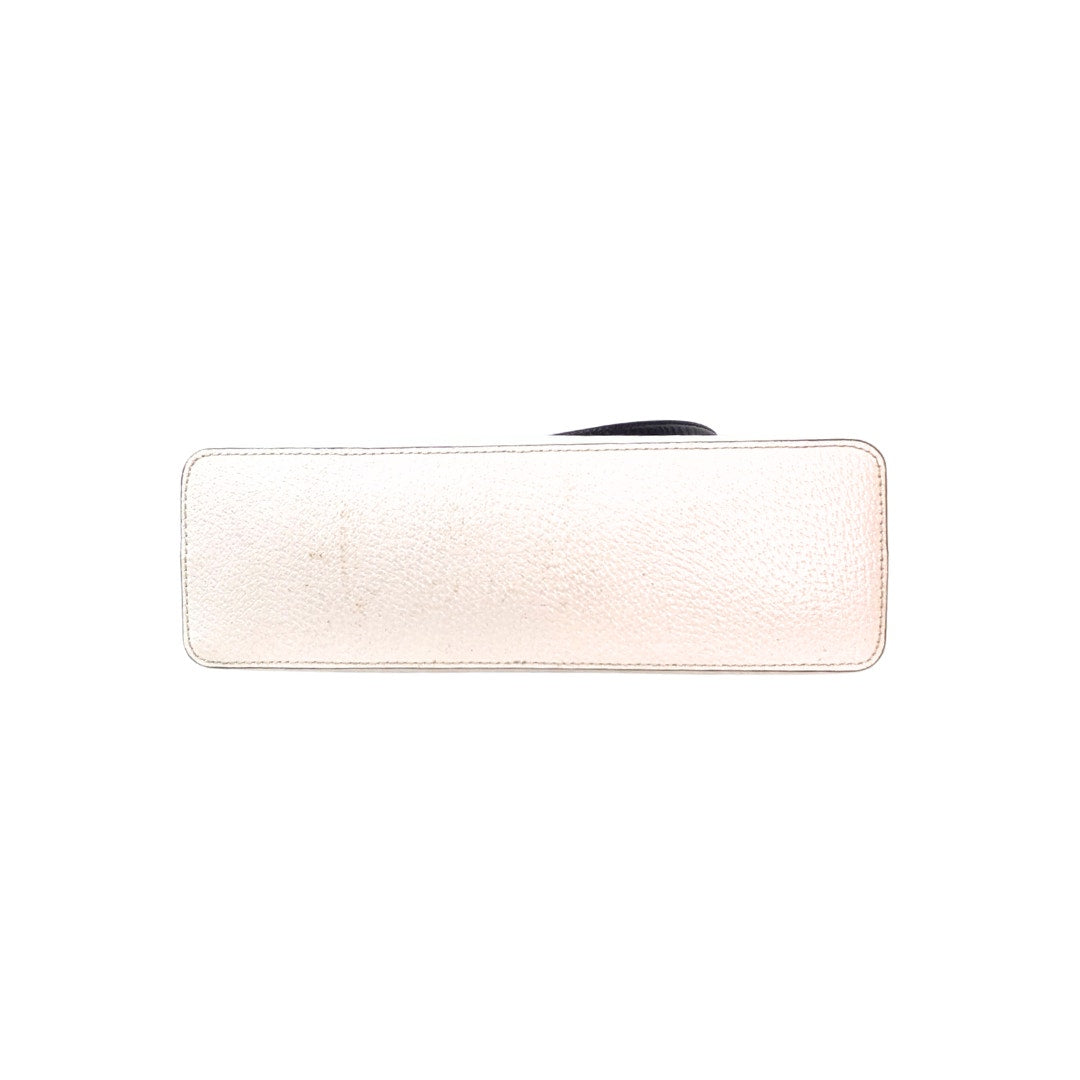 The view of the bottom of the Kate Spade New York Millie Grove Street Crossbody Bag in White and Black, captured on the white background. 