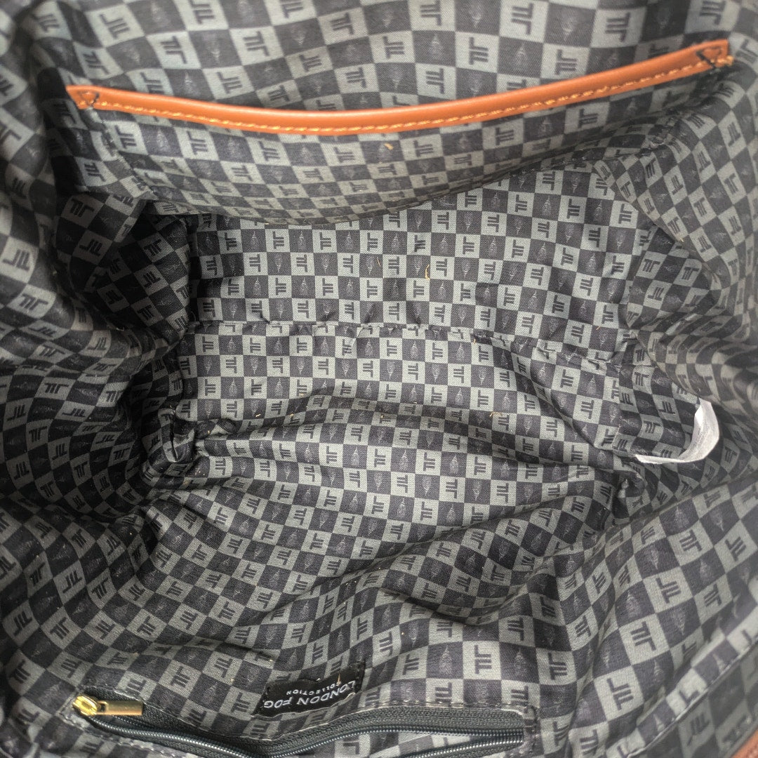 The lined interior of the London Fog Faux Leather Crossbody / Shoulder Handbag.