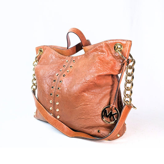 A pre-owned Michael Kors Astor Leather Shoulder Bag in brown color with gold-tone hardware, two top handles, and a chain shoulder strap.