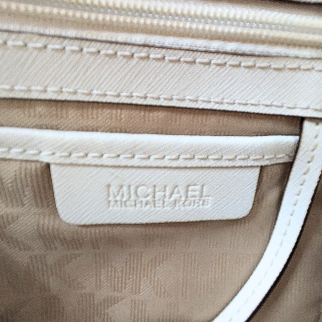 The logo patch in the Michael Kors Saffiano Leather Savannah Medium Satchel Handbag.