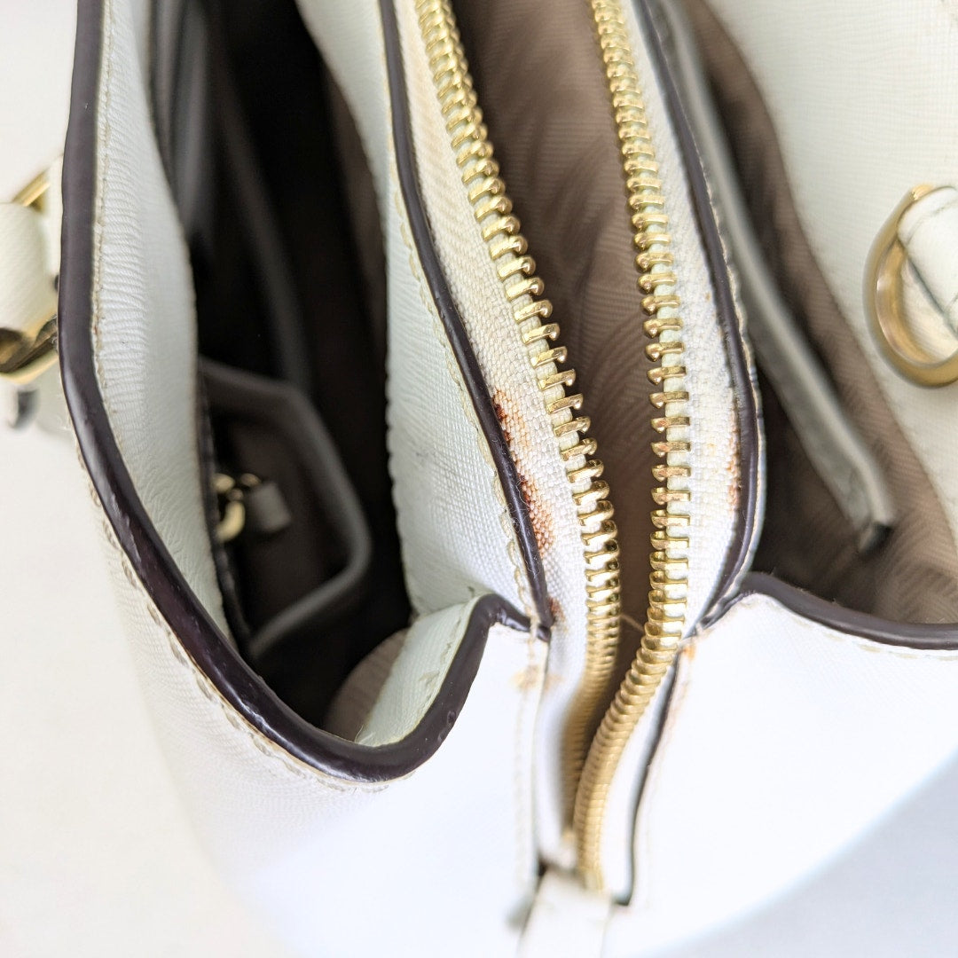 The view of the stain on the zipper canvas on the Michael Kors Saffiano Leather Savannah Medium Satchel Handbag.