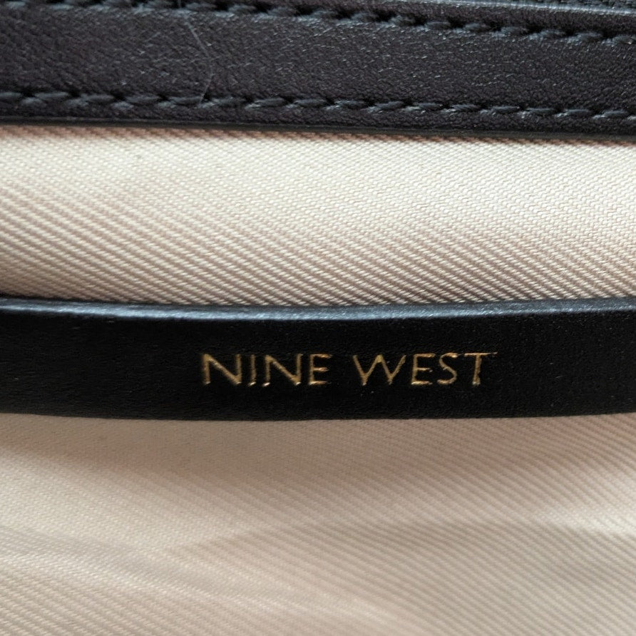 The close-up view of the leather embossed logo inside the Nine West Bedford Animal Print Chain Strap Shoulder Bag.