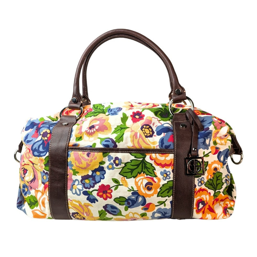 Pre-owned Giani Bernini Floral Print Canvas Diper Bag/ Travel Bag/ Duffle Bag photographed from the front side. 
