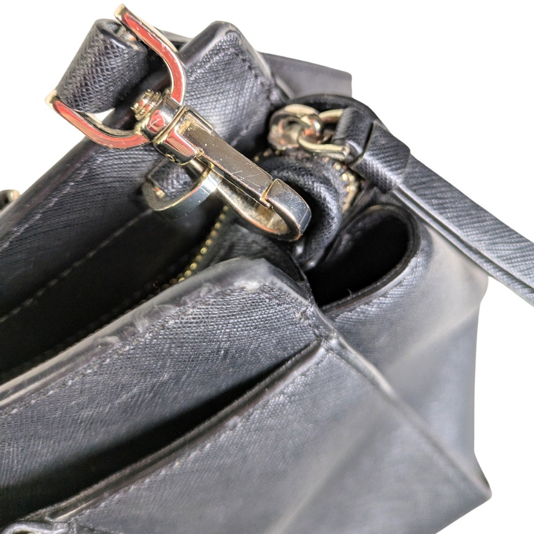 The view of the hardware of the Kate Spade Cameron Satchel Crossbody Bag in black. 
